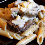 Savor Garlic Butter Steak with Creamy Parmesan Rigatoni Delight